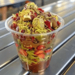 Dubai chocolate strawberry on marble with gold and pistachio