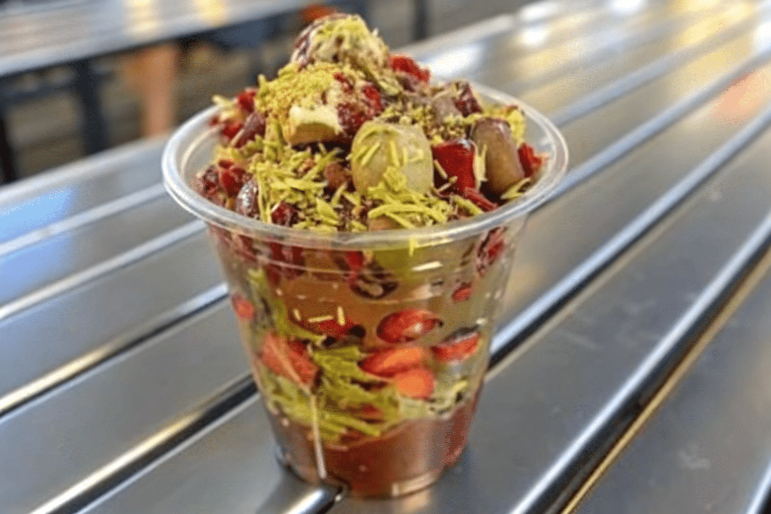 Dubai chocolate strawberry on marble with gold and pistachio